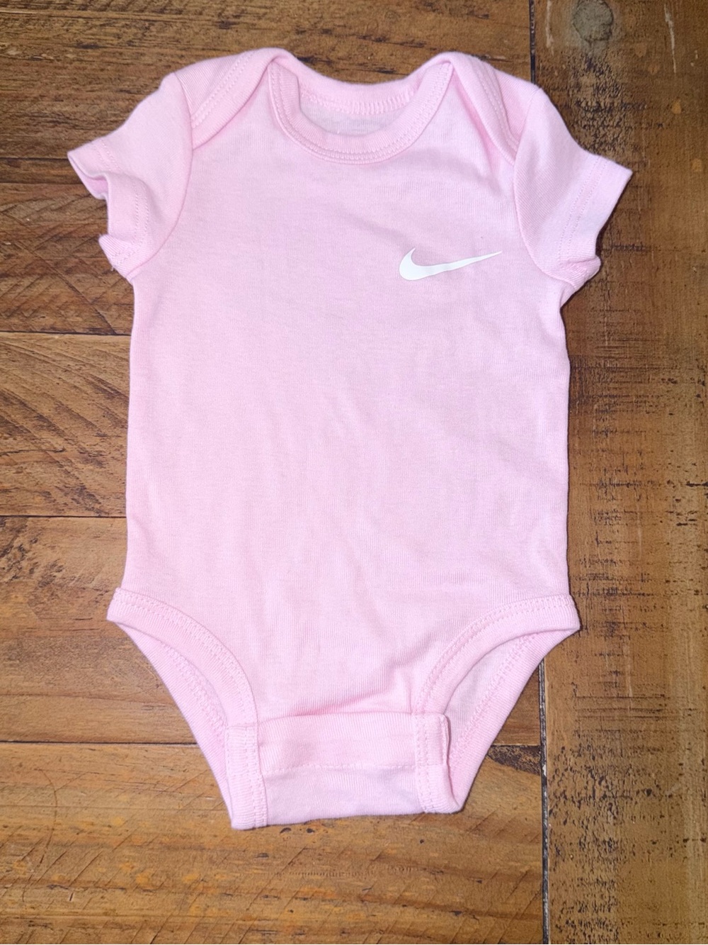 Nike Light Pink Infant Short-Sleeve Bodysuit with White Swoosh